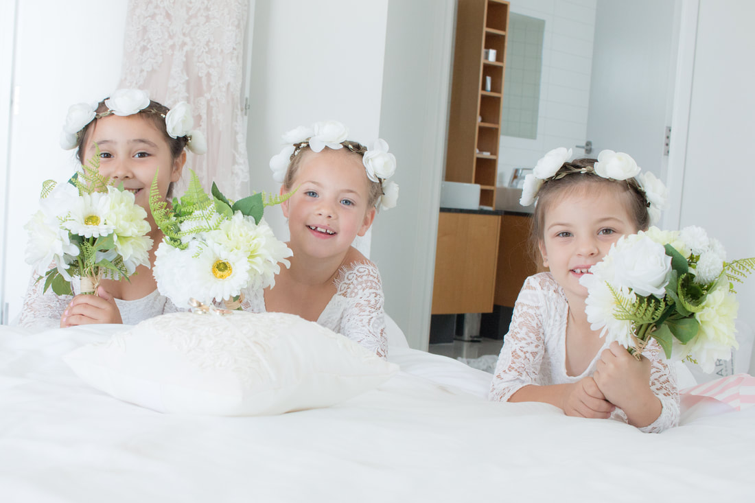 3 girls as bridesmaid holding flowers at wedding